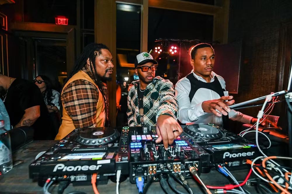 Marshawn Lynch, Marcus Peters playing instruments and performing on a stage