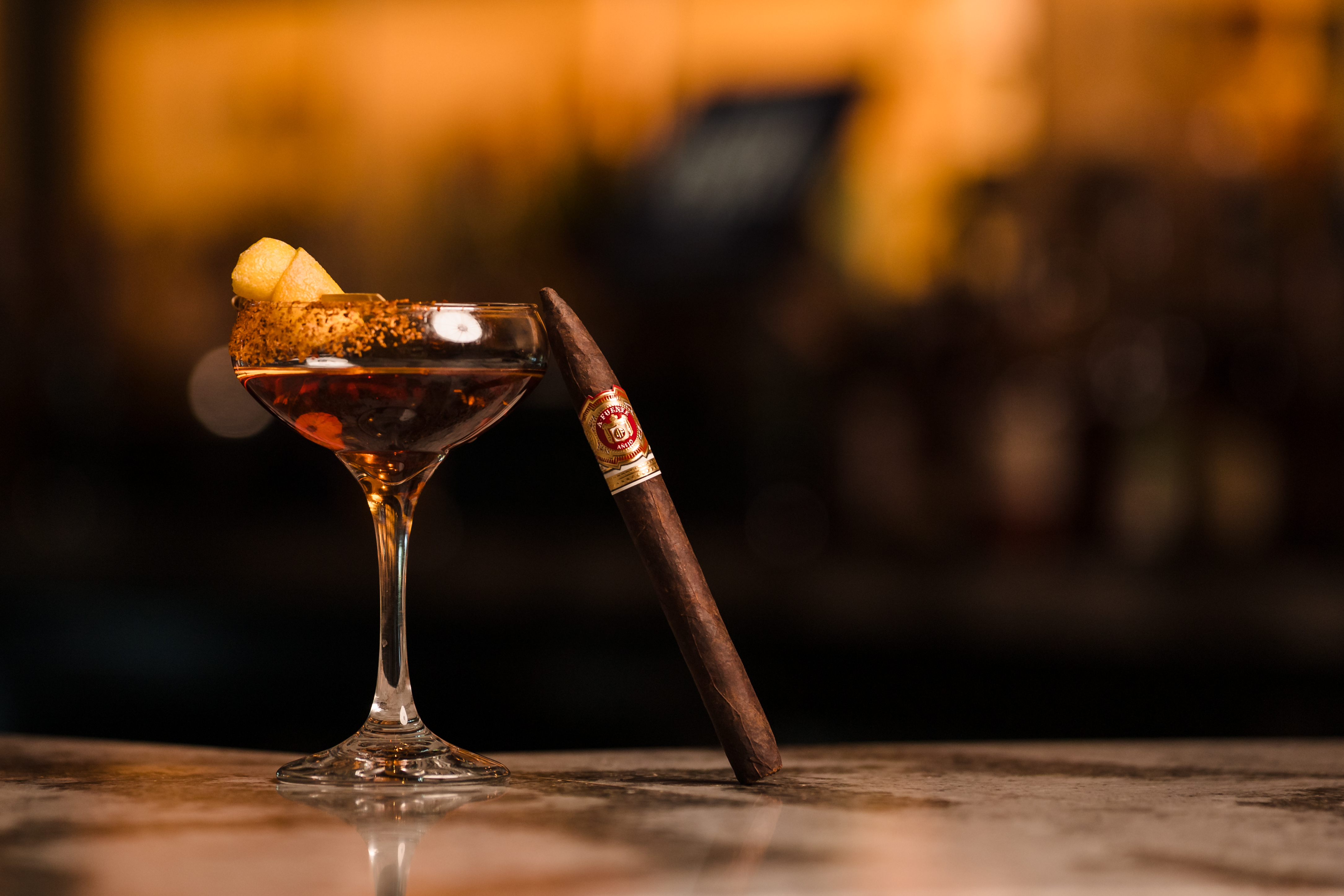 a close up of a wine glass sitting on a table