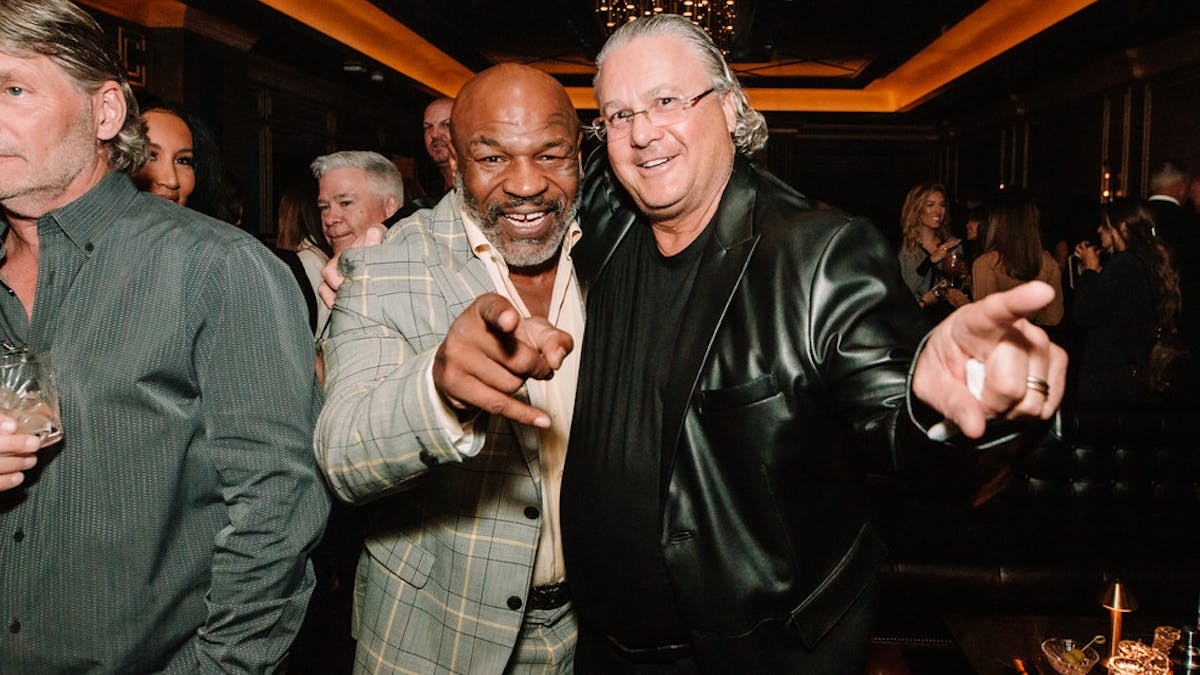 Mike Tyson, David Chesnoff holding wine glasses
