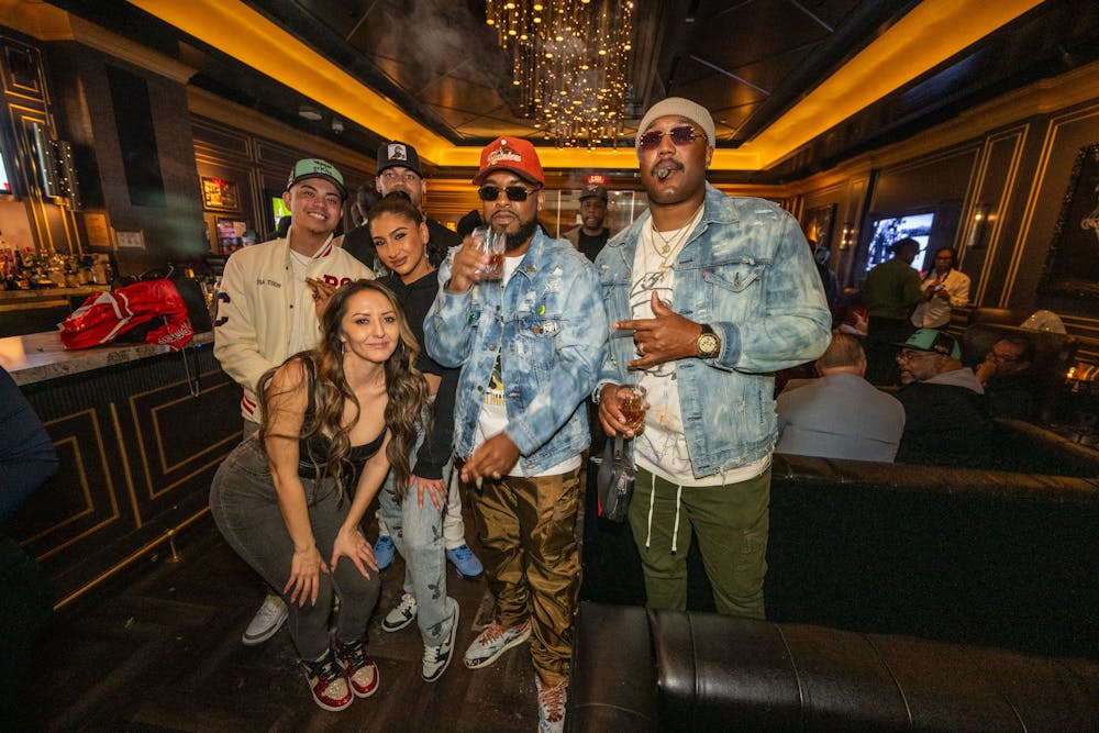 a group of people standing in front of a bus