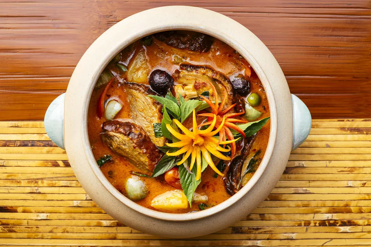 a bowl of food sitting on top of a wooden table