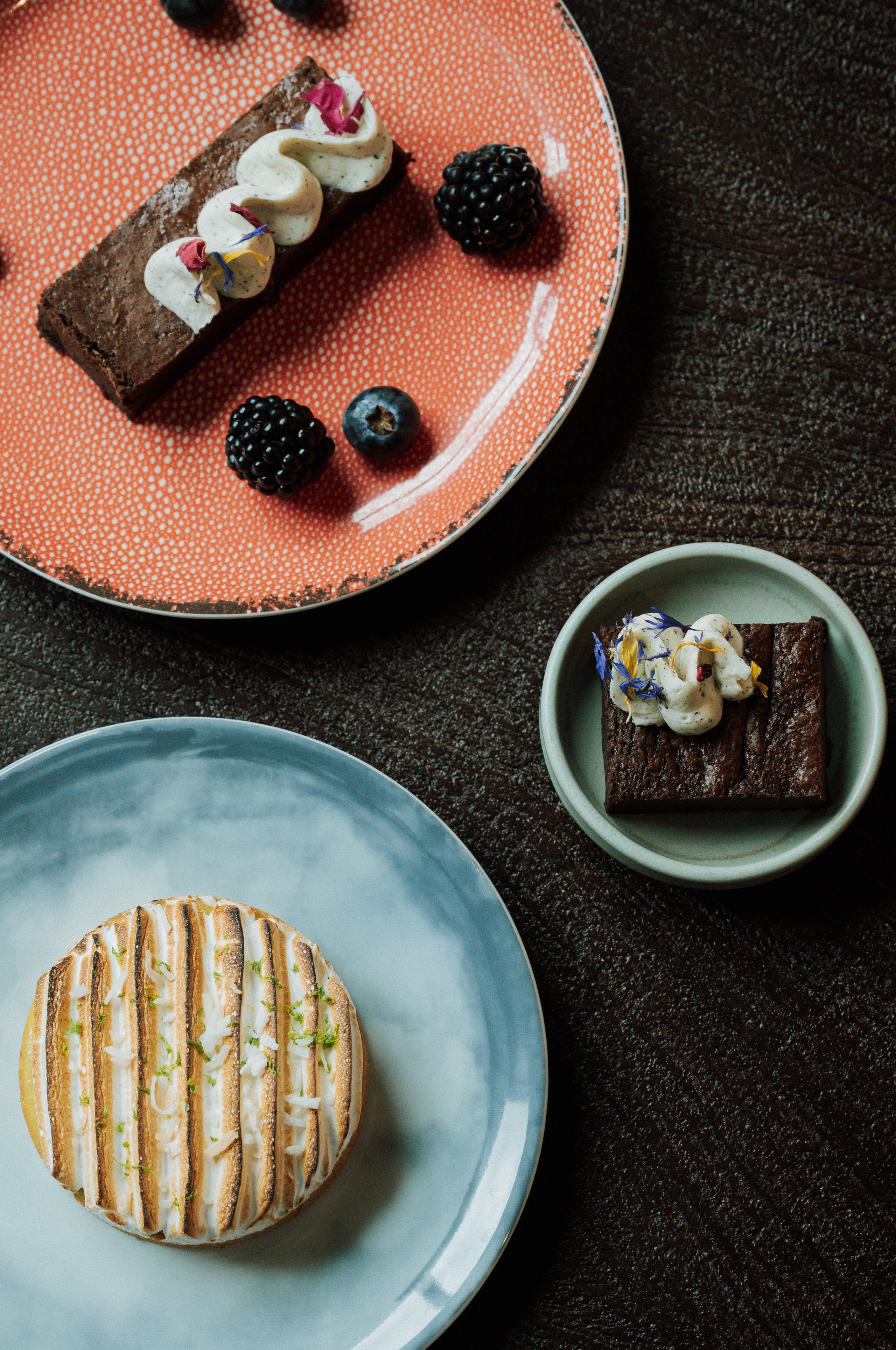 a group of plates of desserts