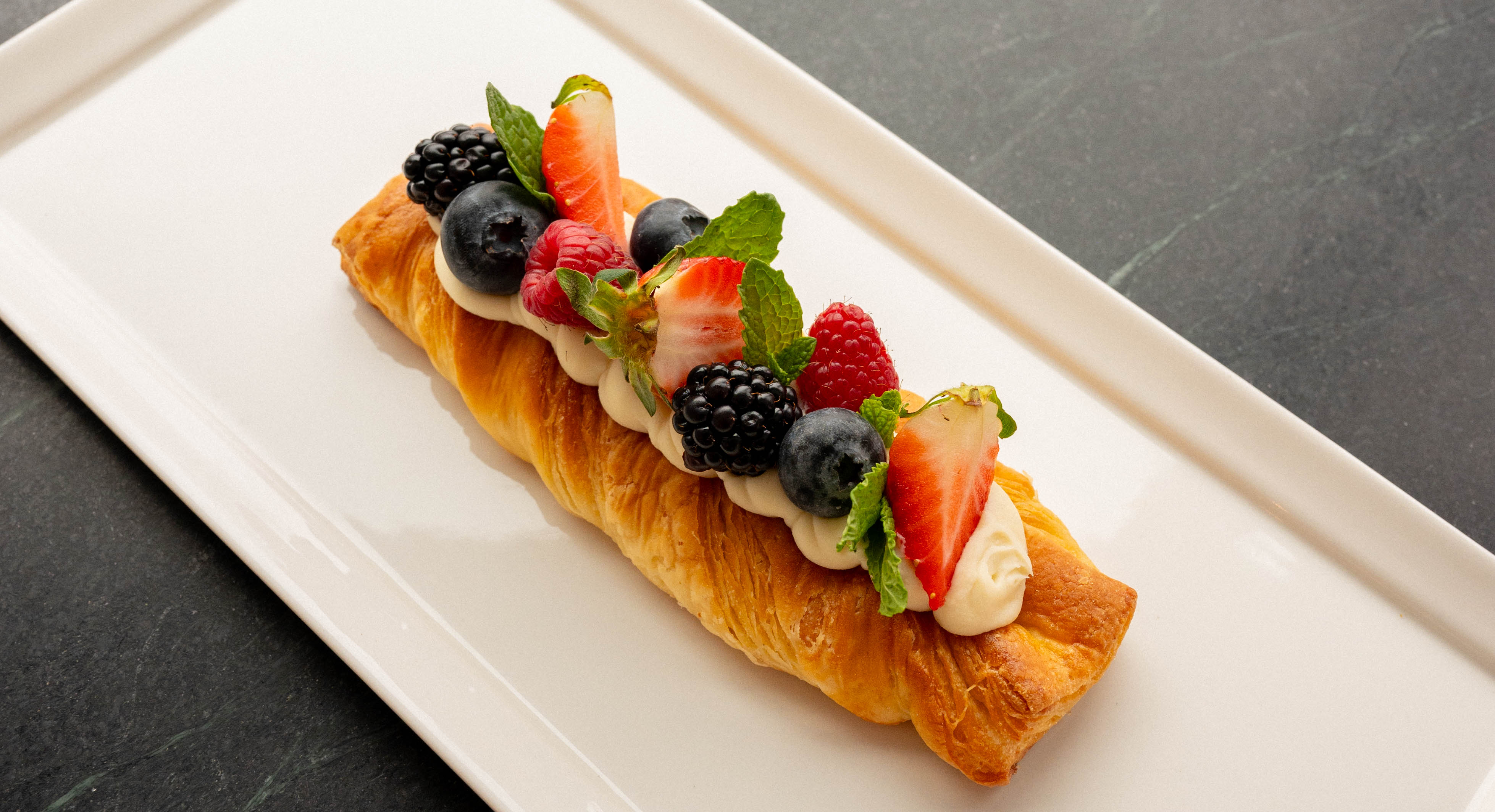 a plate of food with a slice of cake on a table