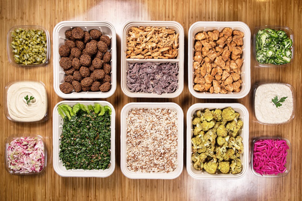 a plastic container filled with different types of food on a table