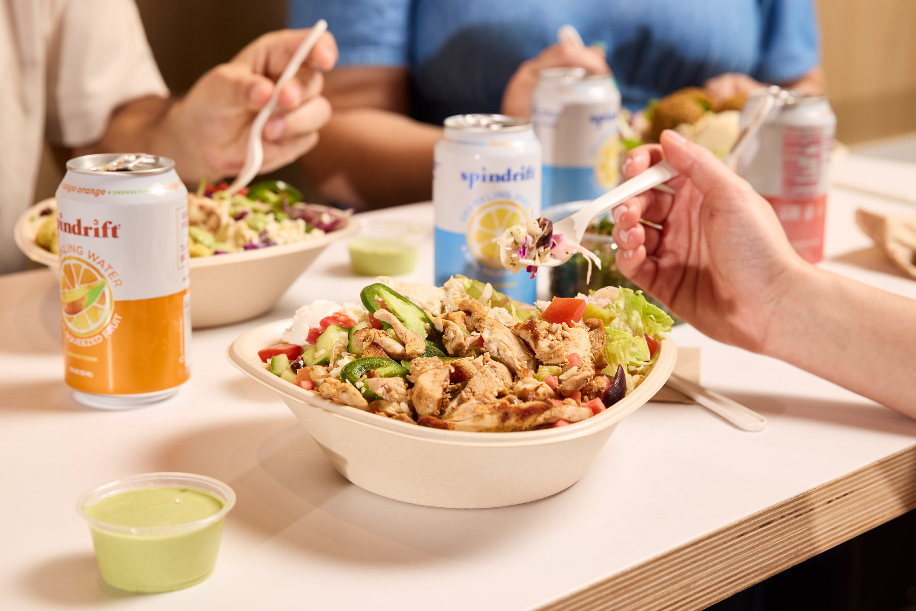 a woman sitting at a table with a plate of food