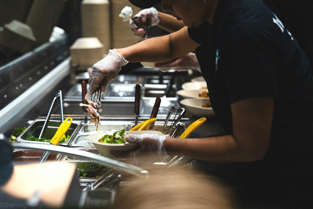 a man preparing food on top of a cutting board