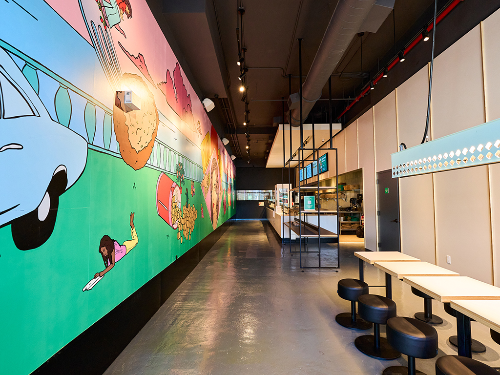 a group of people standing in a kitchen preparing food