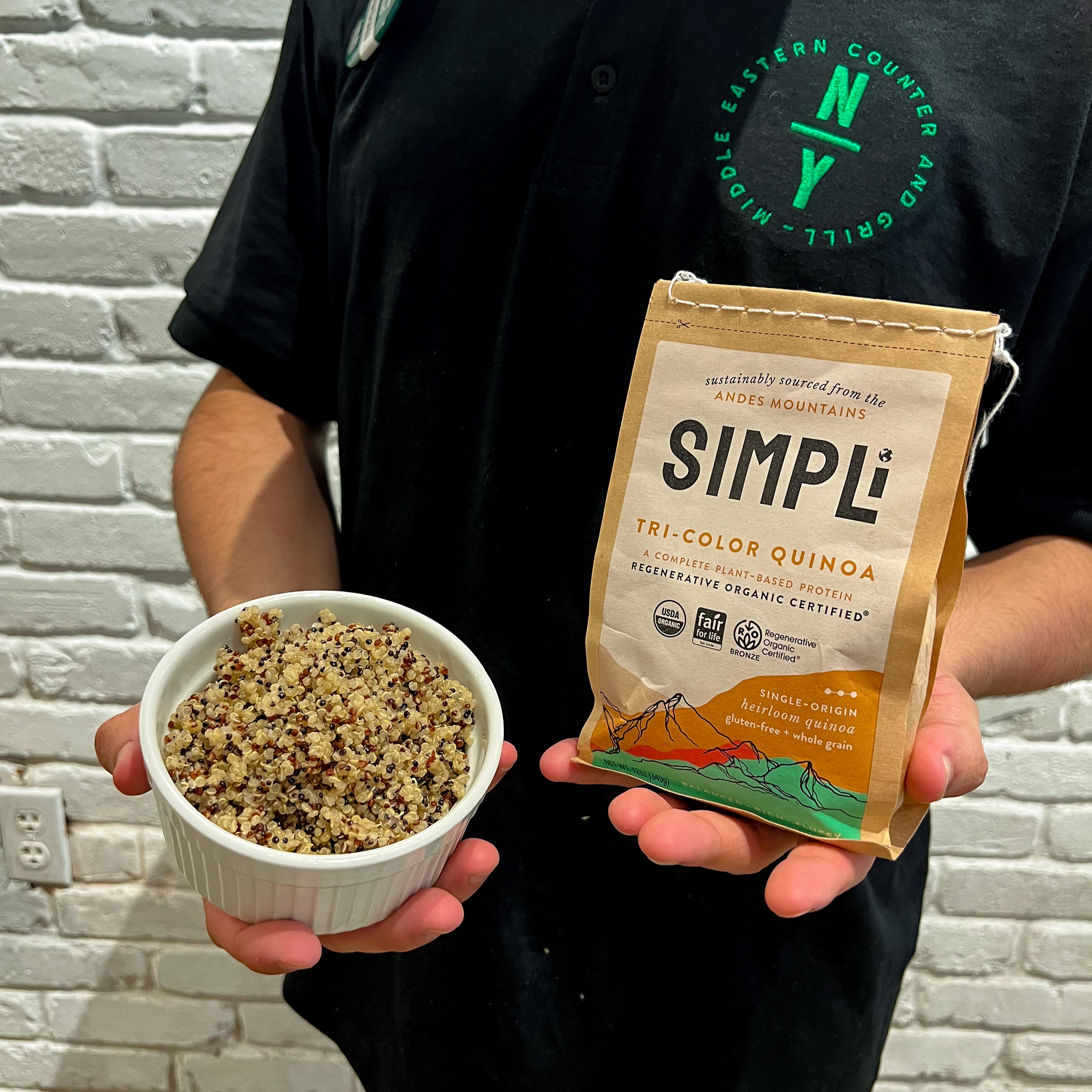 Bowl  of quinoa is held by NAYA team member. Naya now offers quinoa as a base option. Get all your essential amino acids eating quinoa bowls at a Naya near you. Find us near you in NYC, NJ, CT, PA