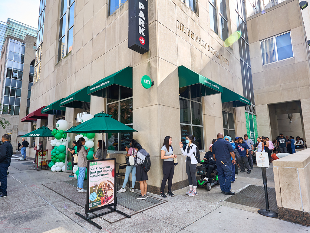 a group of people preparing food in a kitchen