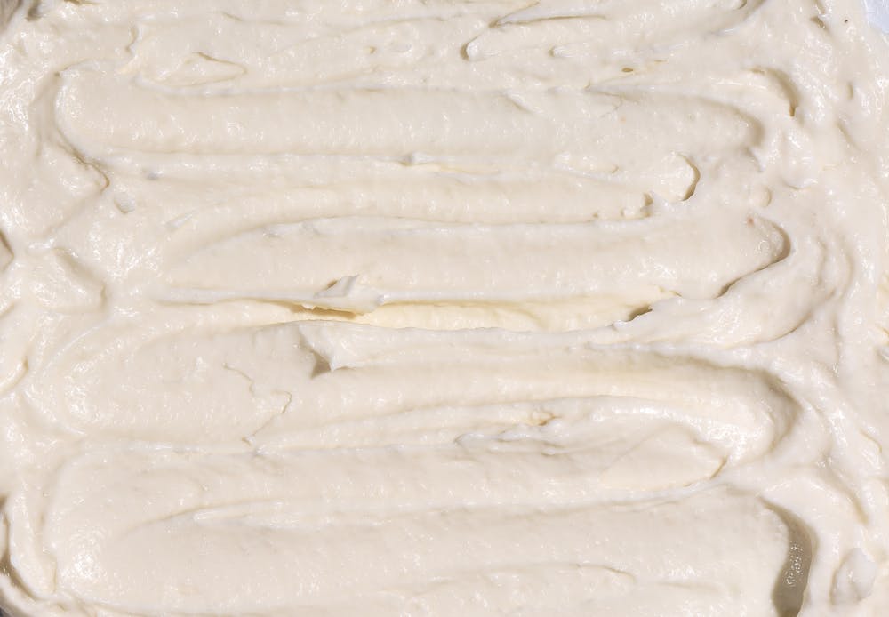 Naya's toum (garlic sauce) spread out. Try a side of this delicious condiment at a Naya near you