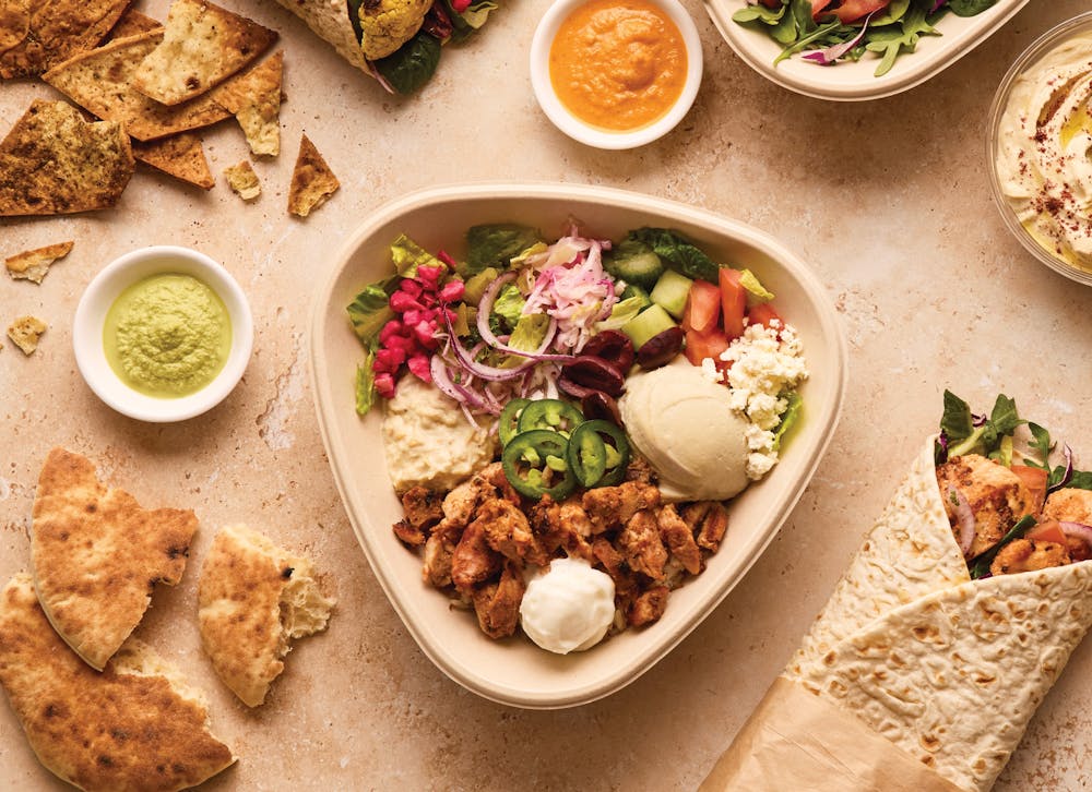 Naya roll and bowl featured along side some pita and sauces like toum, garlic sauce