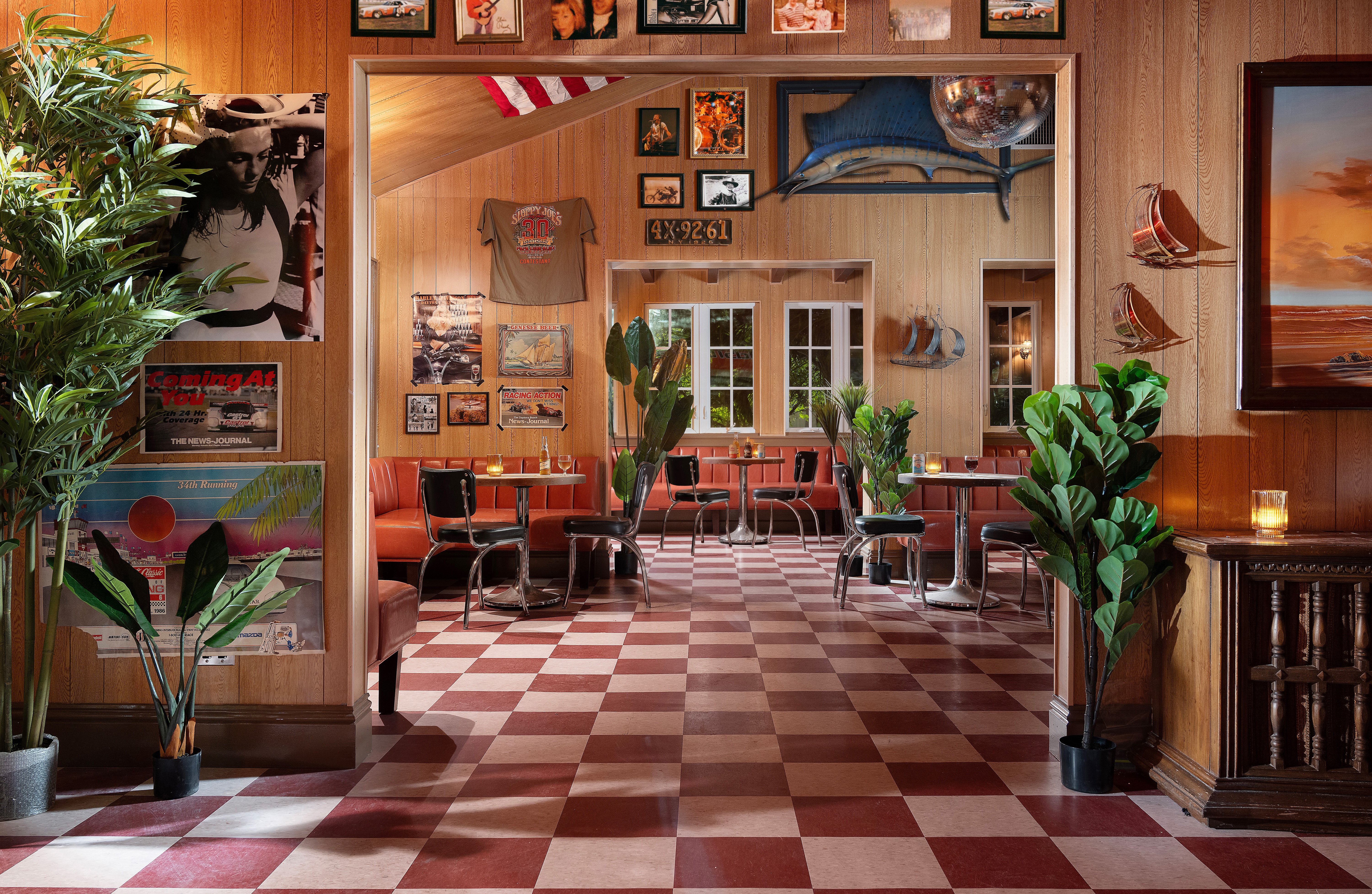 a room filled with furniture and vase of flowers on a table