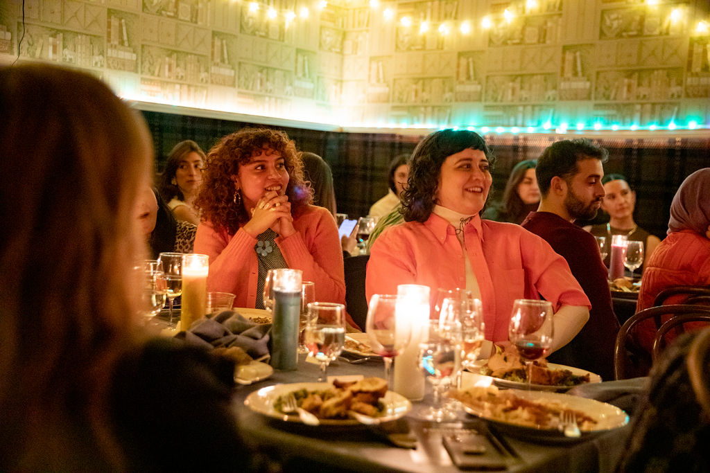 a group of people sitting at a table in a restaurant
