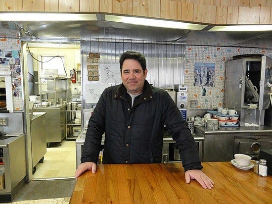 a person posing for the camera in a kitchen