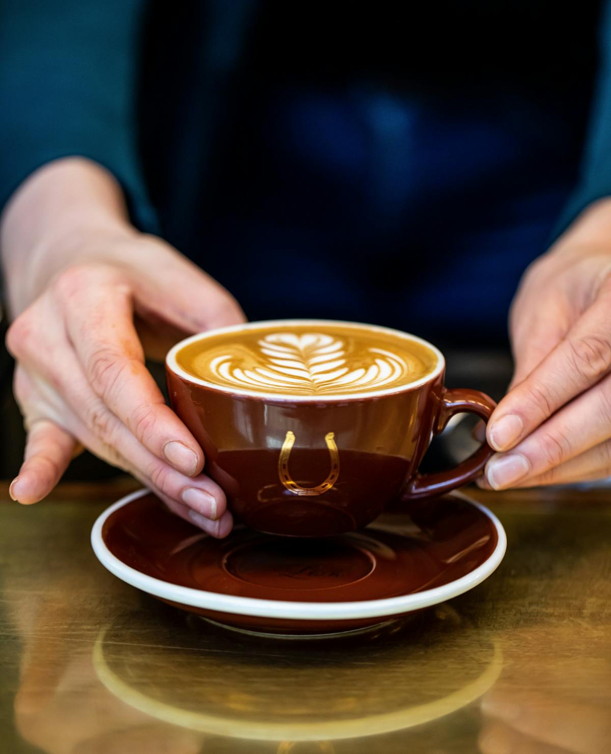 a person holding a latte with latte art