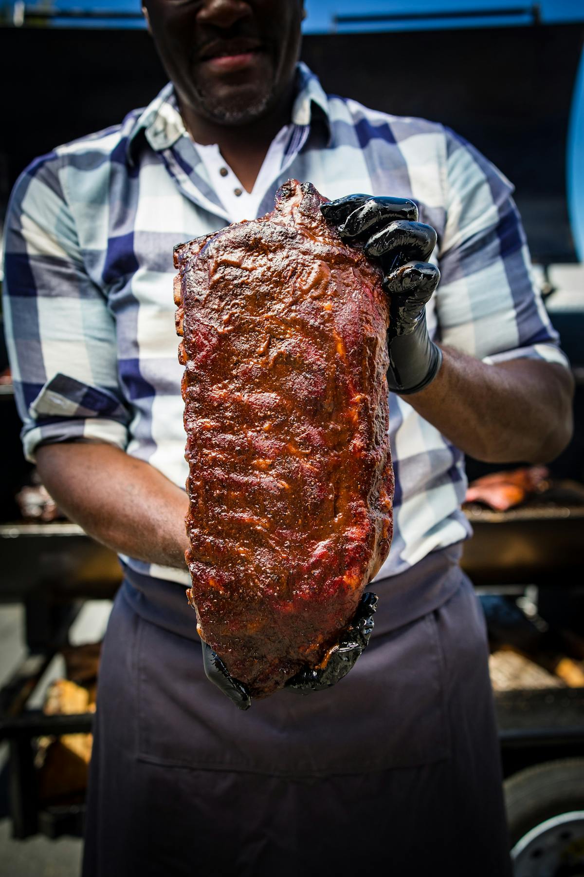 a man holding a rack of ribs