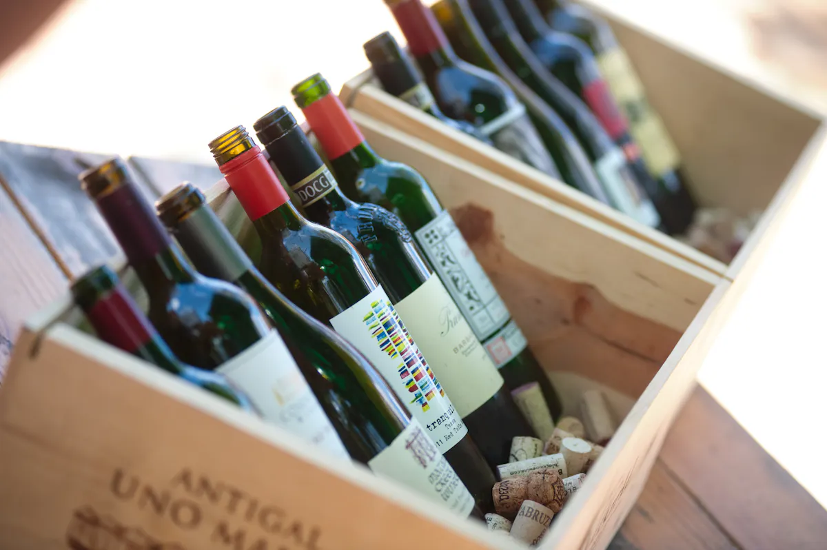 a picture of multiple bottles of wine sitting on wooden boxes