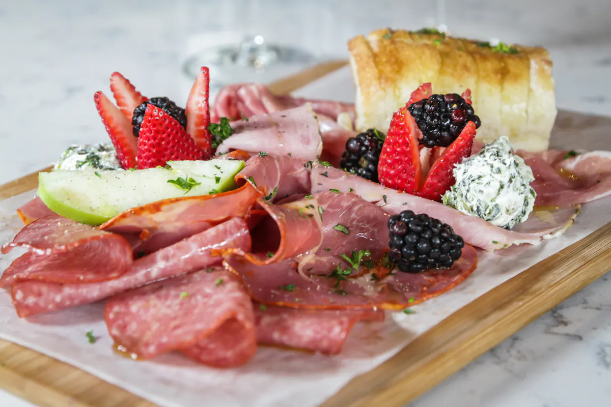 a plate of food with a slice of cake on a table