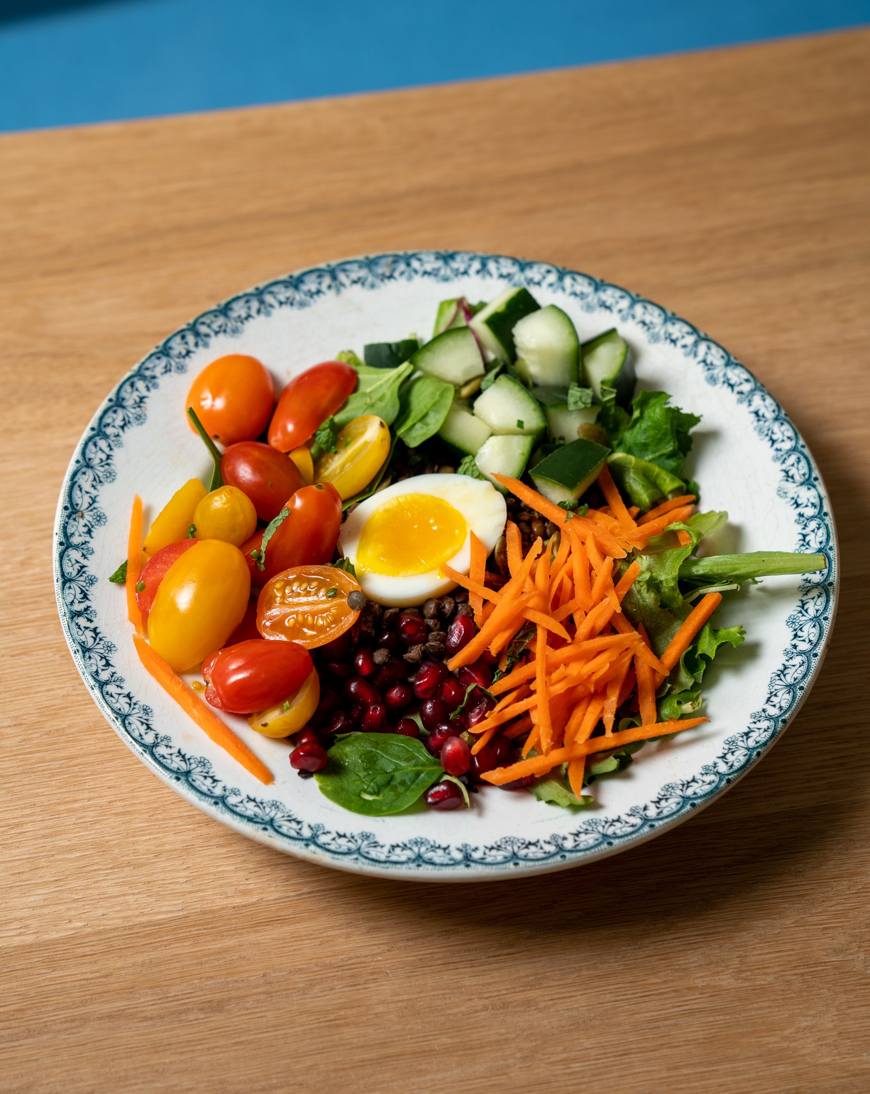 a plate full of food sitting on top of a wooden table