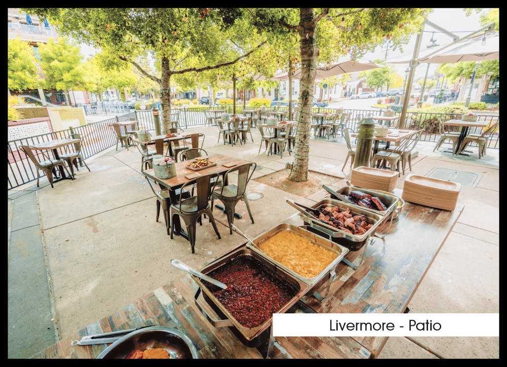 a group of people sitting at a table in a park