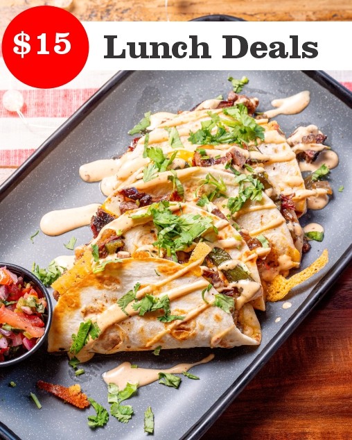 A plate of tacos topped with sauce and cilantro, served with a side of salsa. Promotional banner highlighting $15 lunch deals at Sauced BBQ & Spirits.