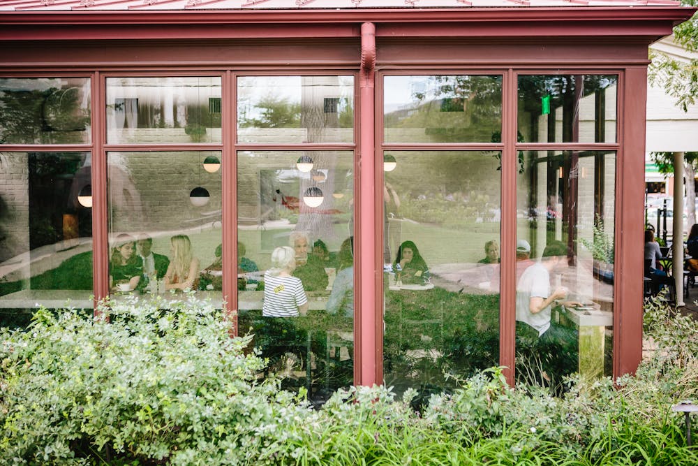 a house with bushes in front of a window