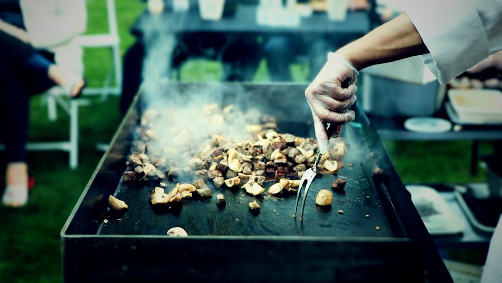 a person cooking food on a grill