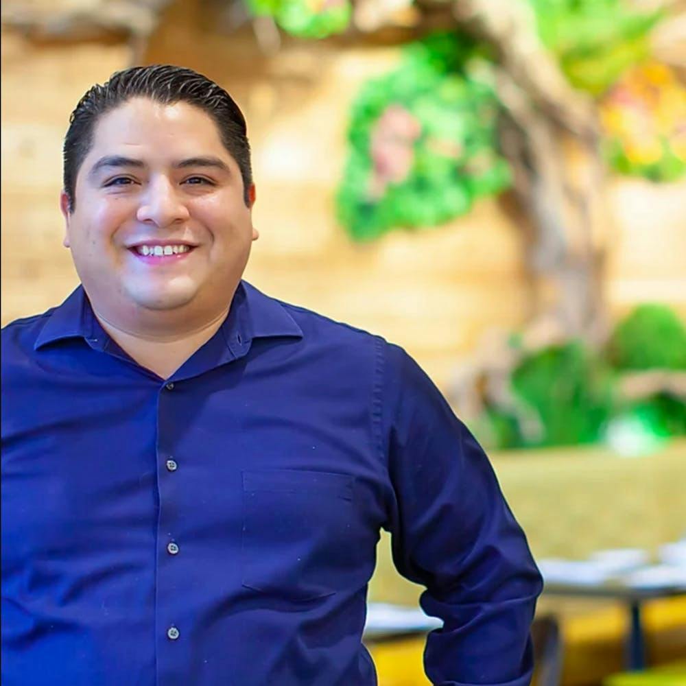 a smiling boy wearing a blue shirt