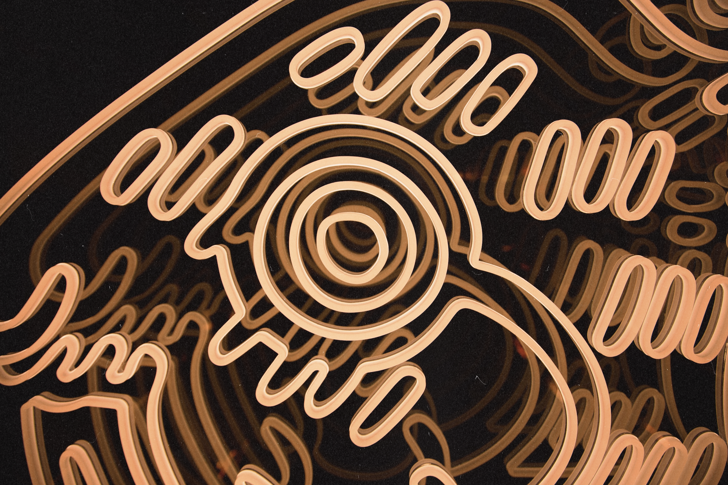 Close-up of glowing neon eye artwork inside Wax Rabbit, featuring warm golden lighting and immersive speakeasy design details.