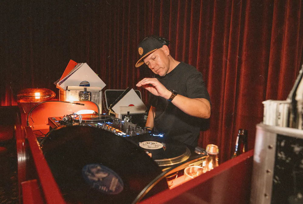 DJ spinning vinyl records at Wax Rabbit, a Las Vegas speakeasy and vinyl bar offering curated music, craft cocktails, and late-night lounge experiences.