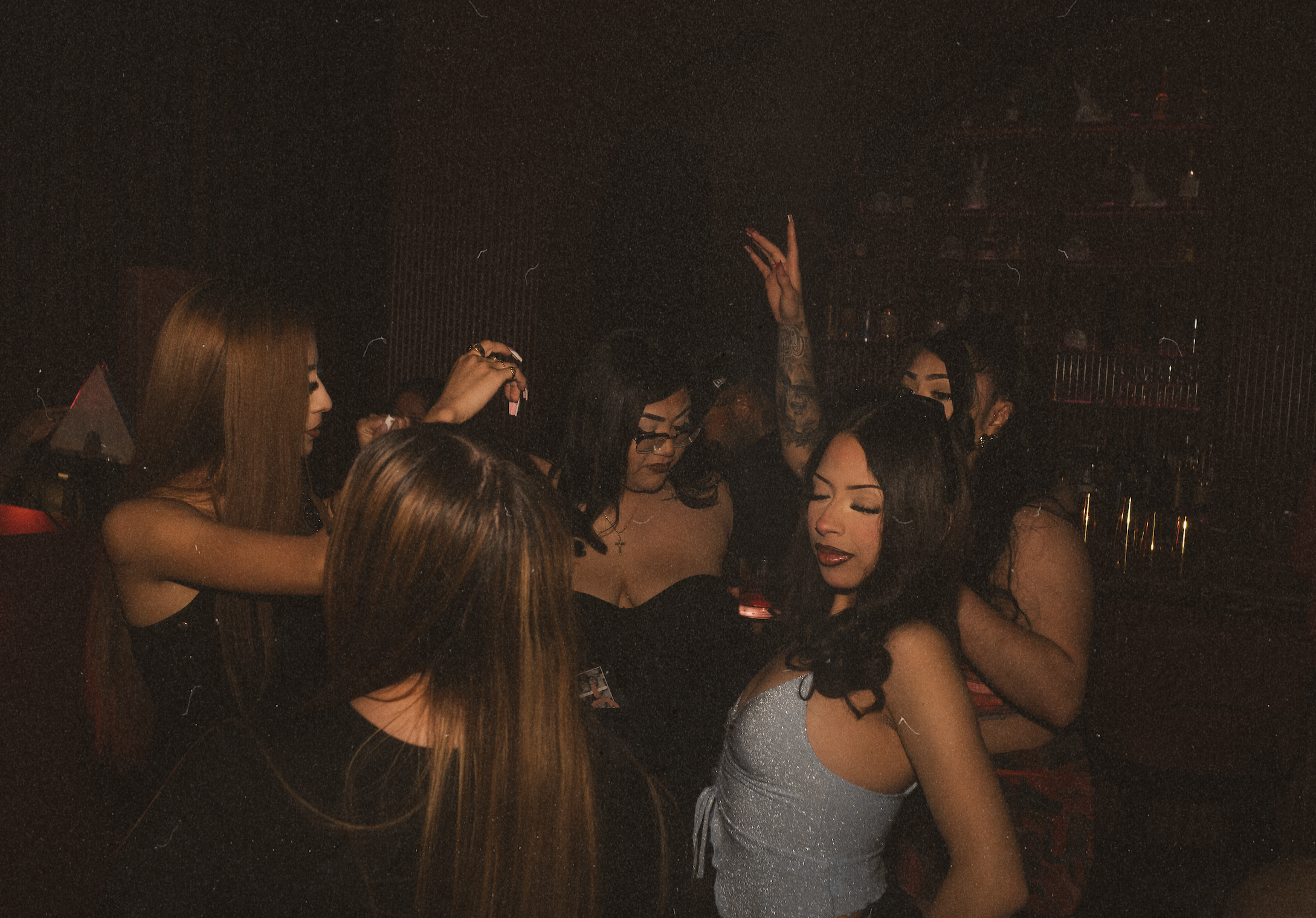Guests dancing beneath moody lighting at Wax Rabbit, a hidden cocktail lounge and cool bar in Las Vegas featuring DJs and elevated nightlife.