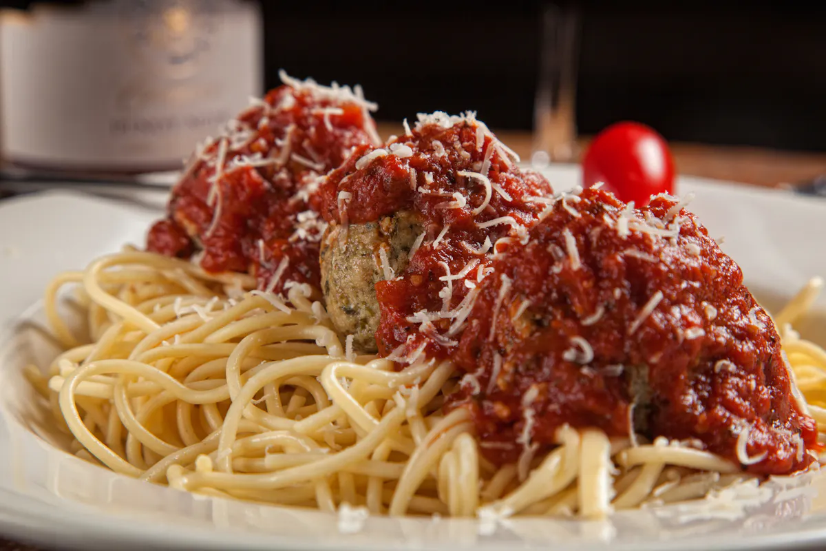 a plate of pasta topped with meatballs and sauce