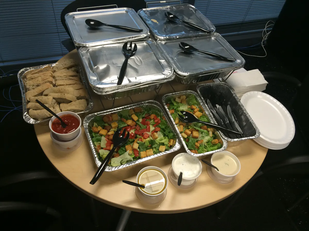 an array of food trays with salads and pastas