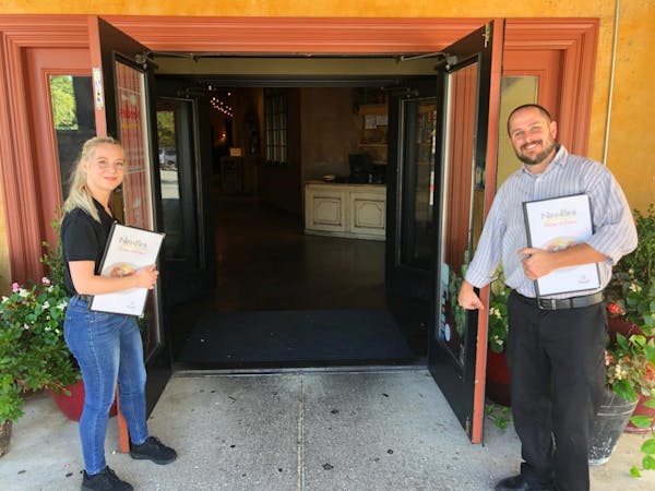 a man and a woman standing in front of a door
