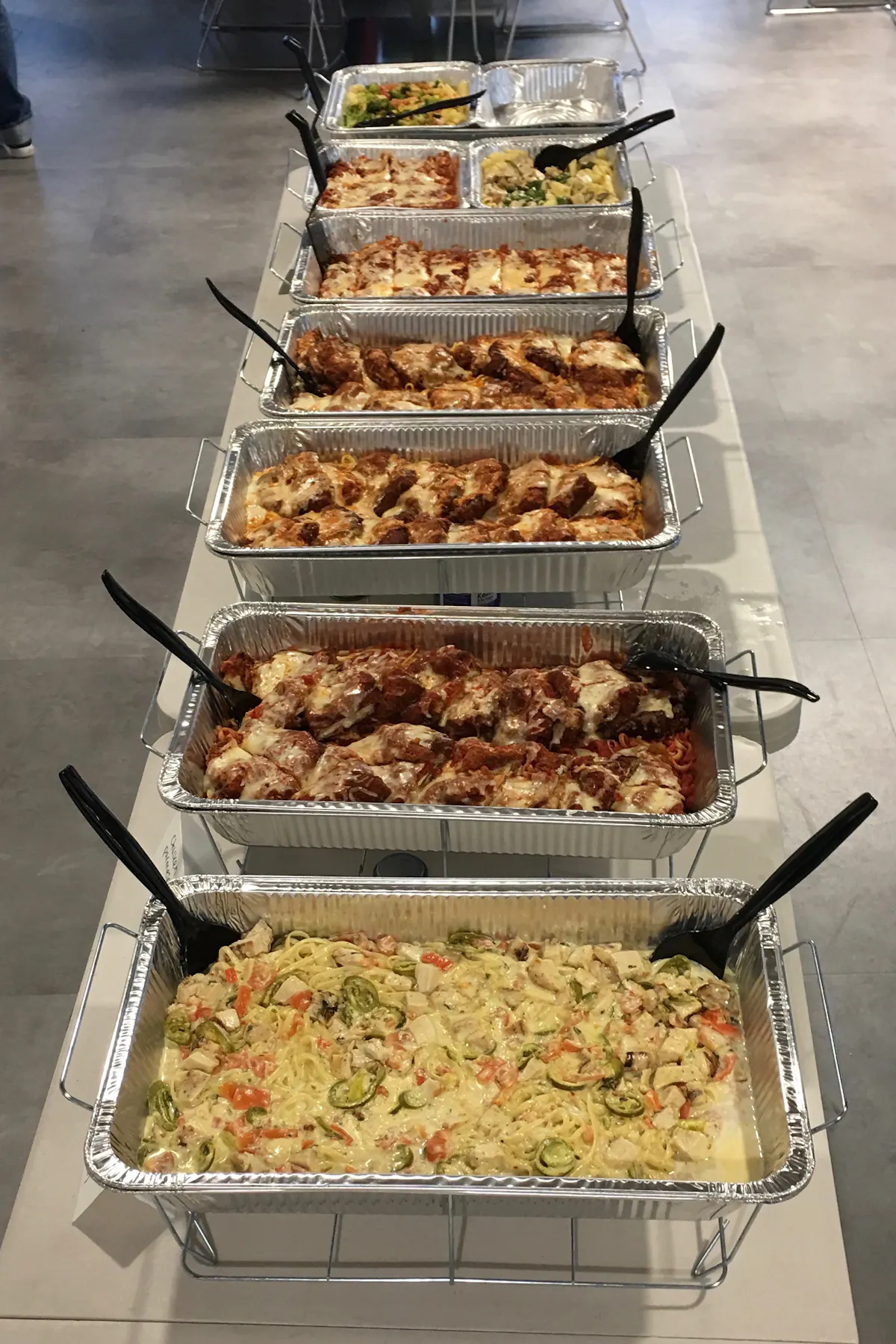 an array of several trays of food lined up