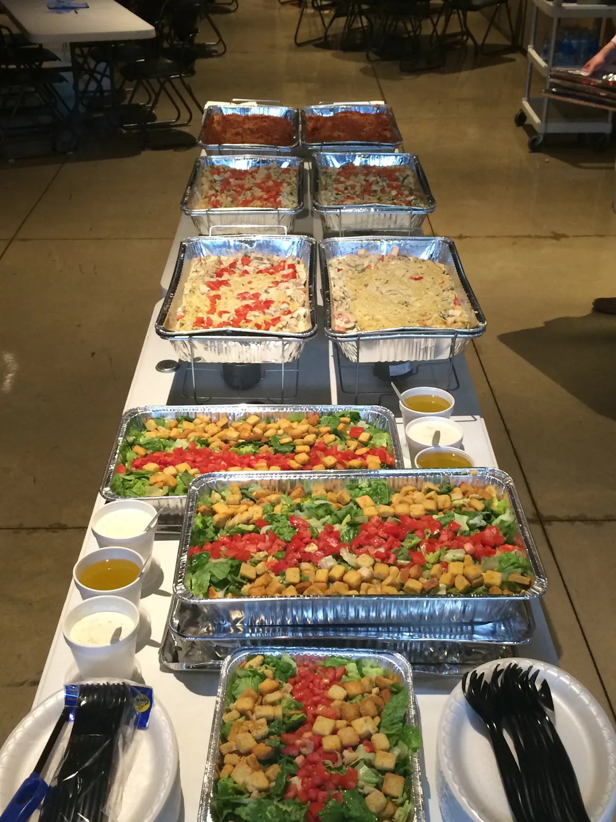 an array of several trays of food lined up