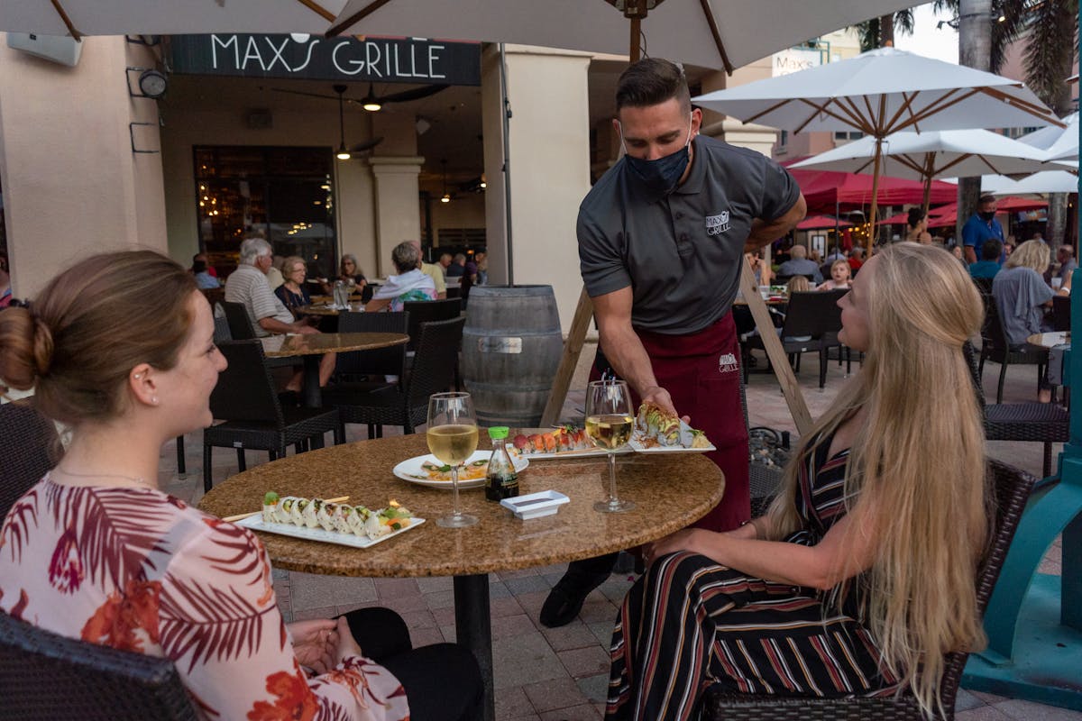 a group of people standing around a table