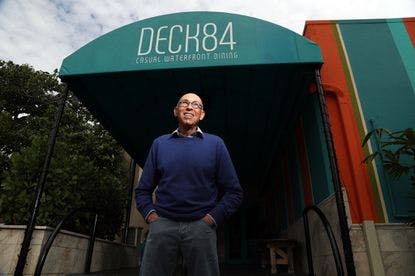 a man standing next to an umbrella