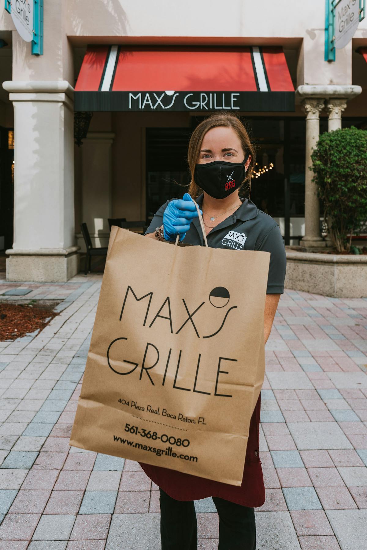 a person holding a sign on a sidewalk