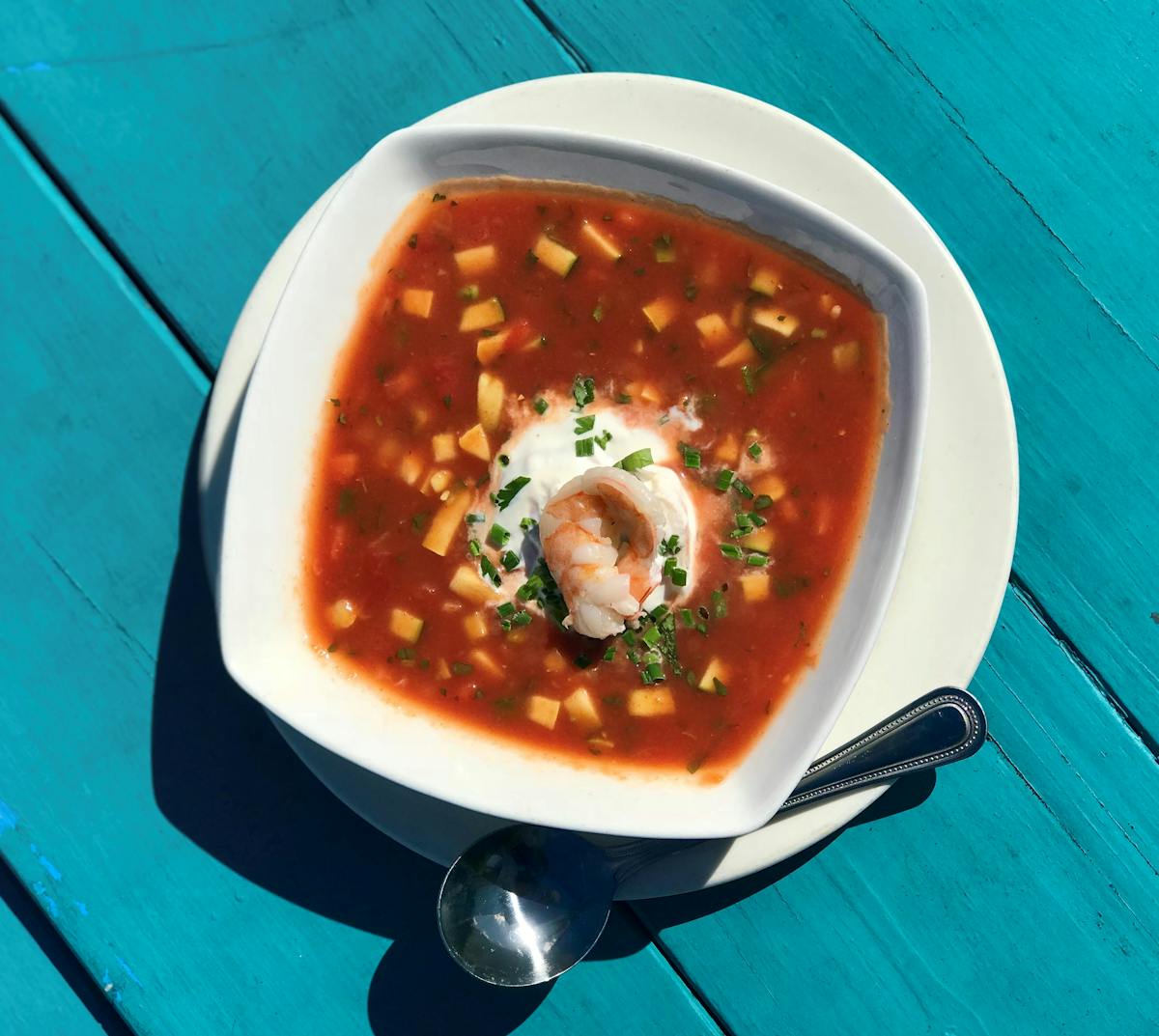 a bowl of soup on a blue plate