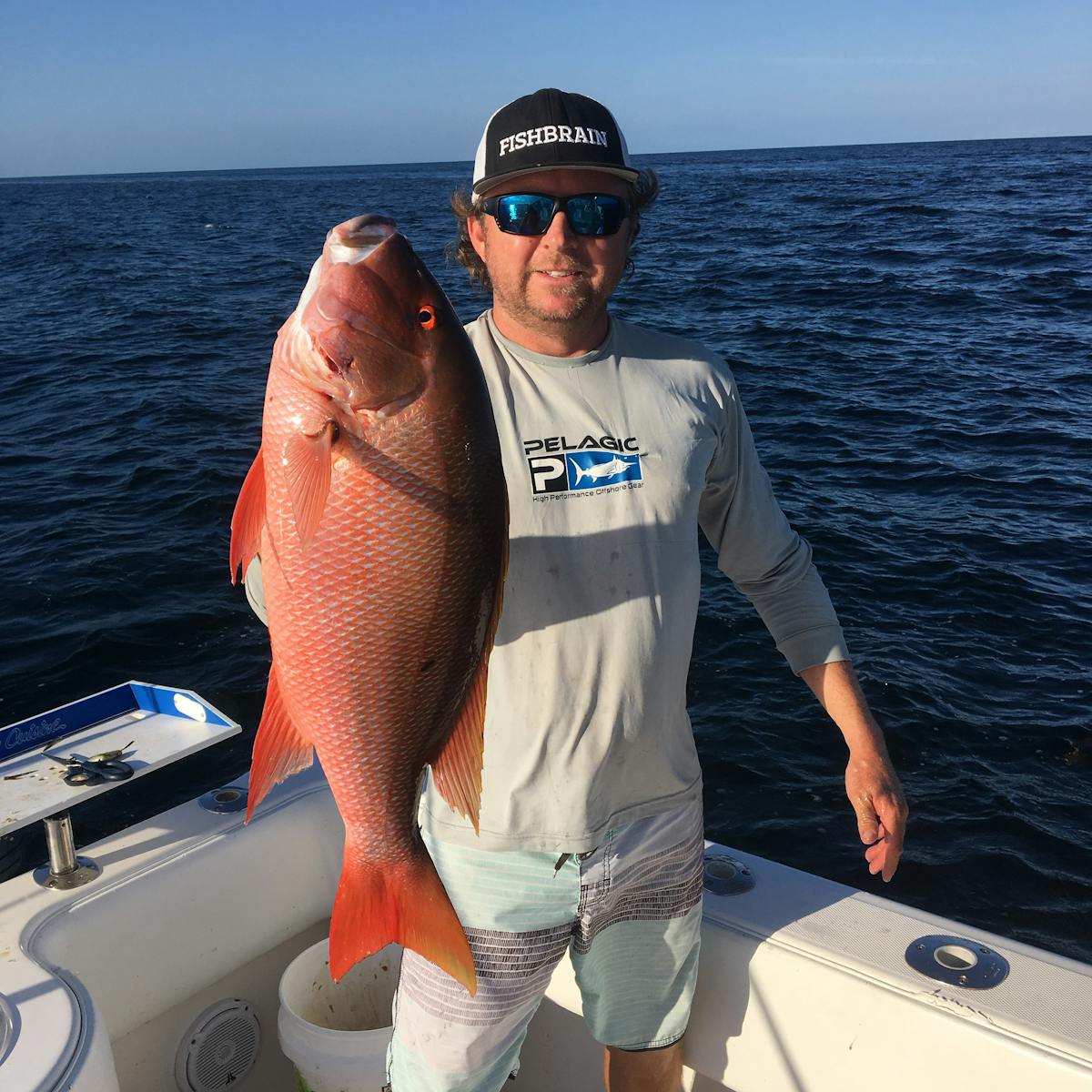 a man holding a fish in the water