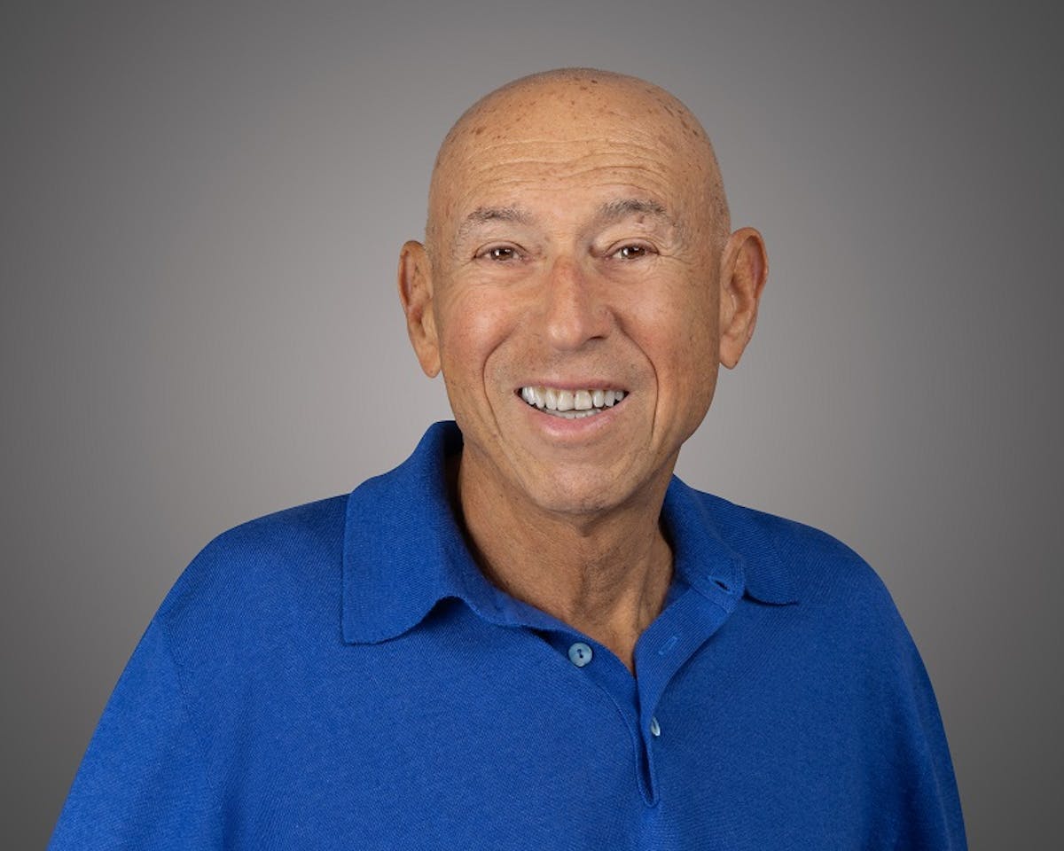 a smiling man in a blue shirt