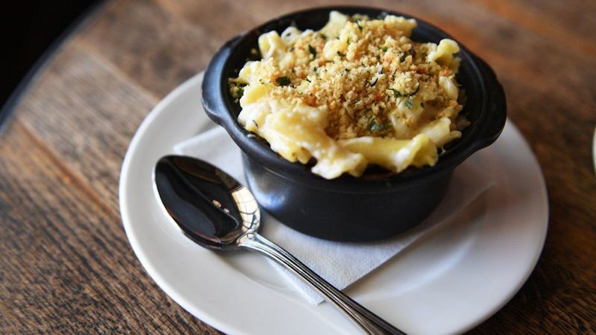 a plate of food and a spoon on a table