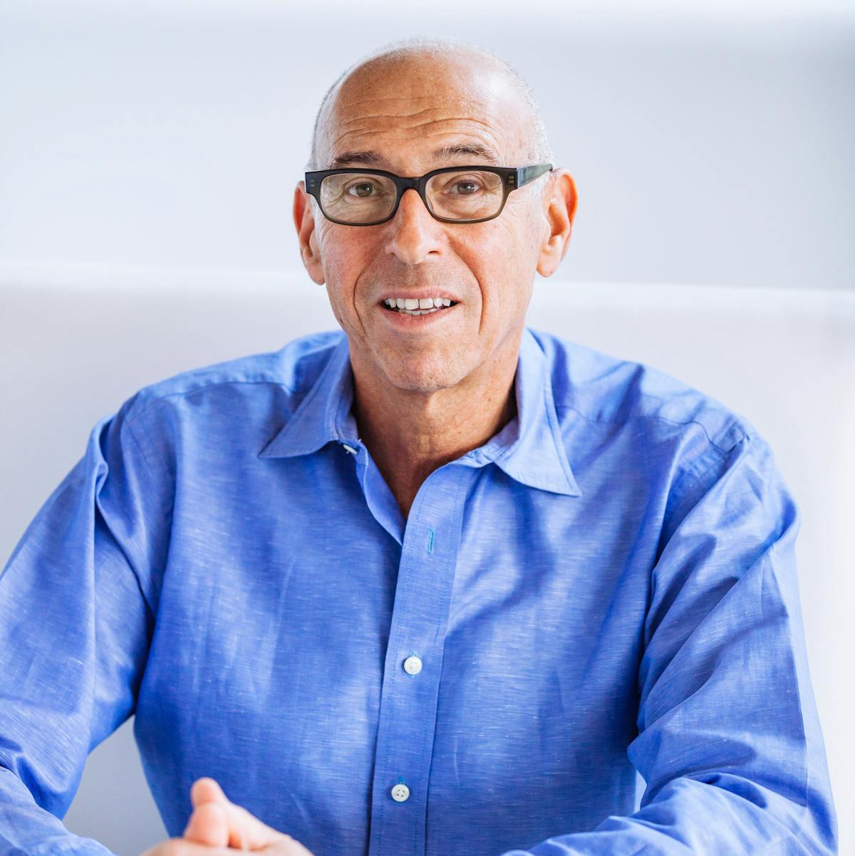 a man wearing glasses and a blue shirt