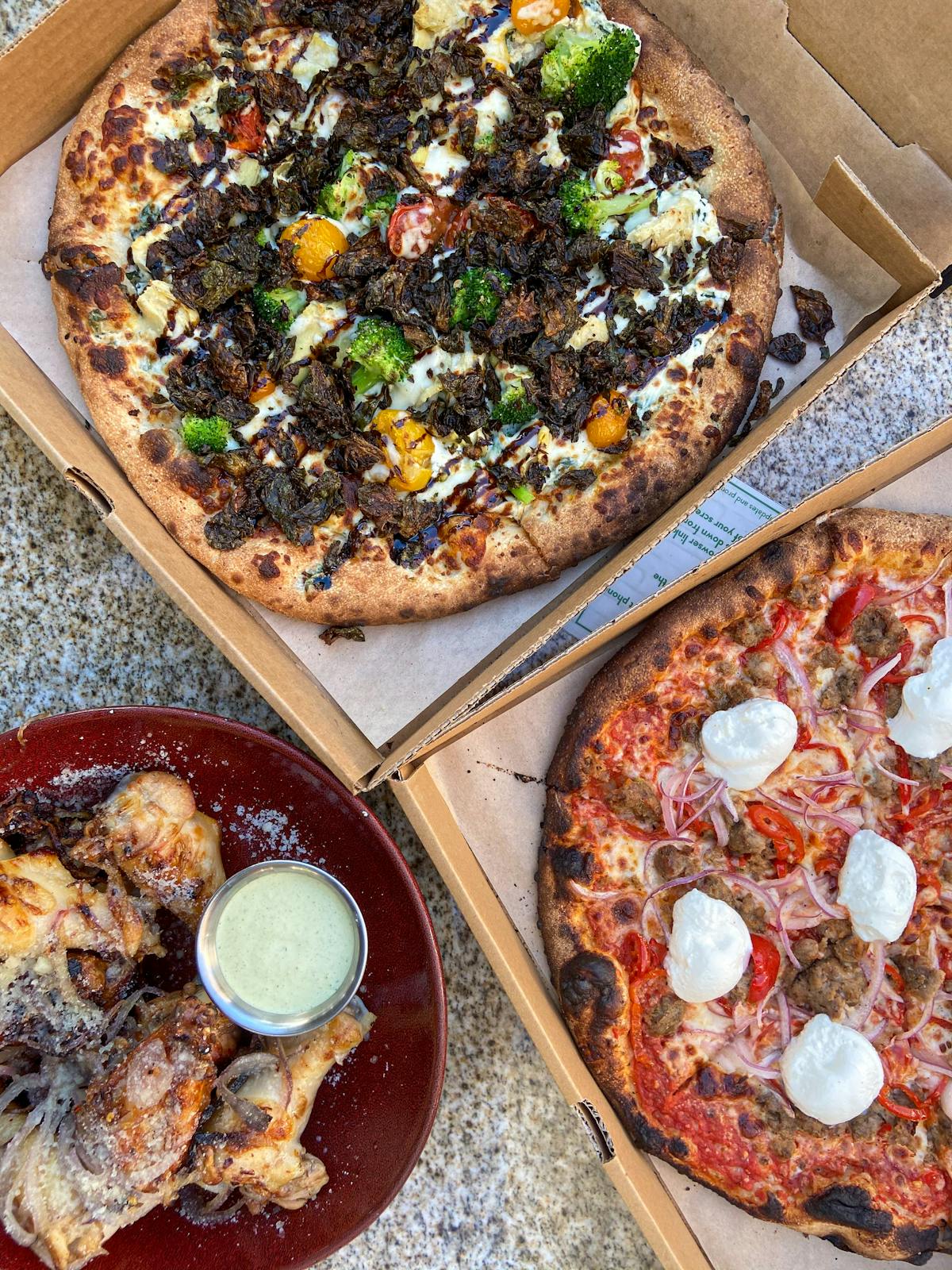 a pizza sitting on top of a wooden table