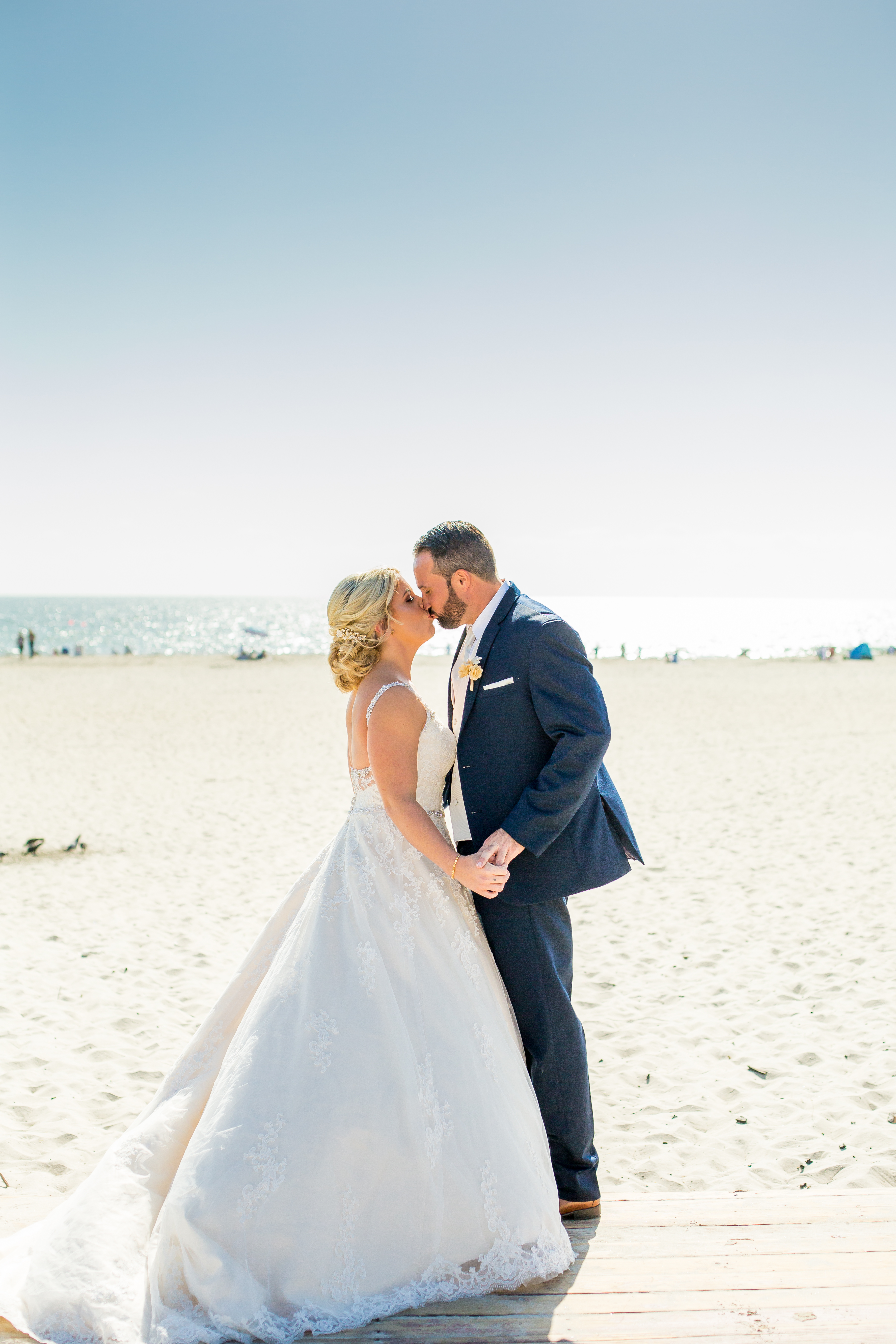 a man and woman kissing on a beach