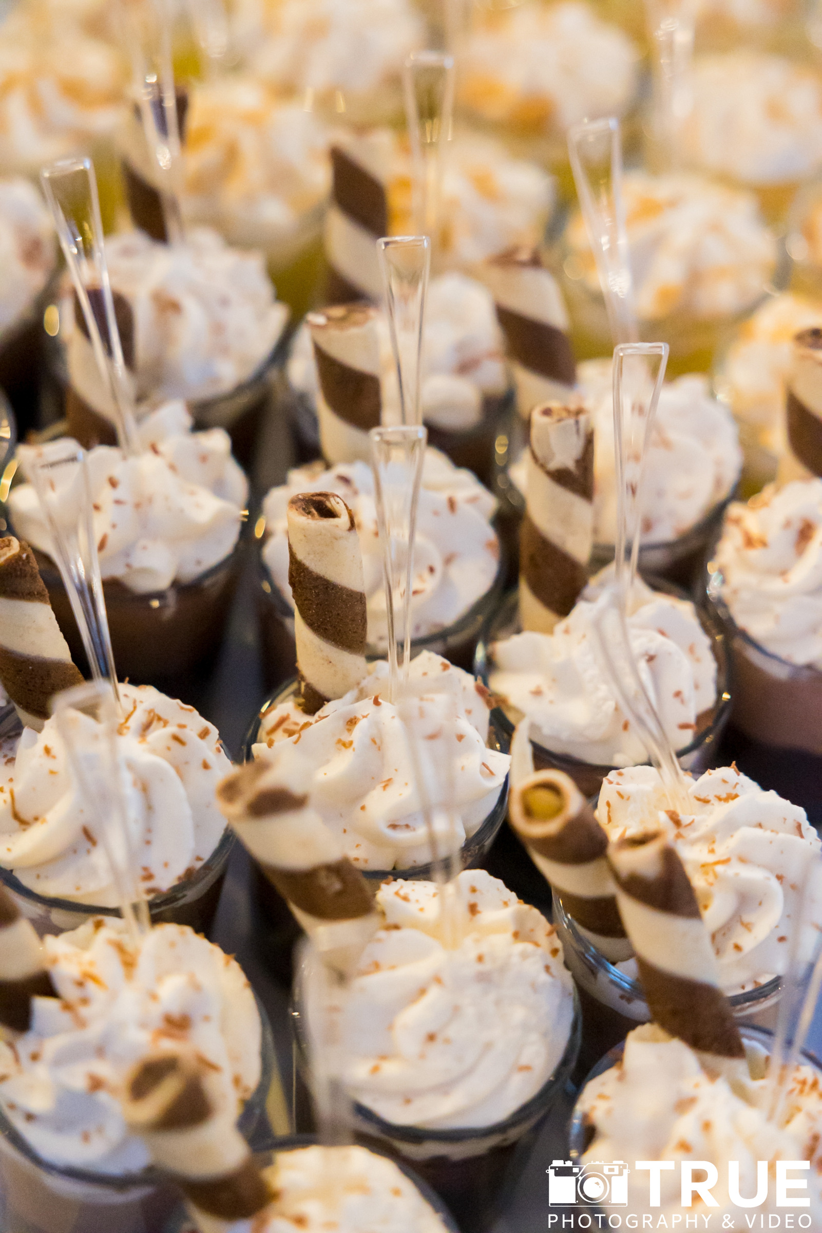 a group of desserts in cups