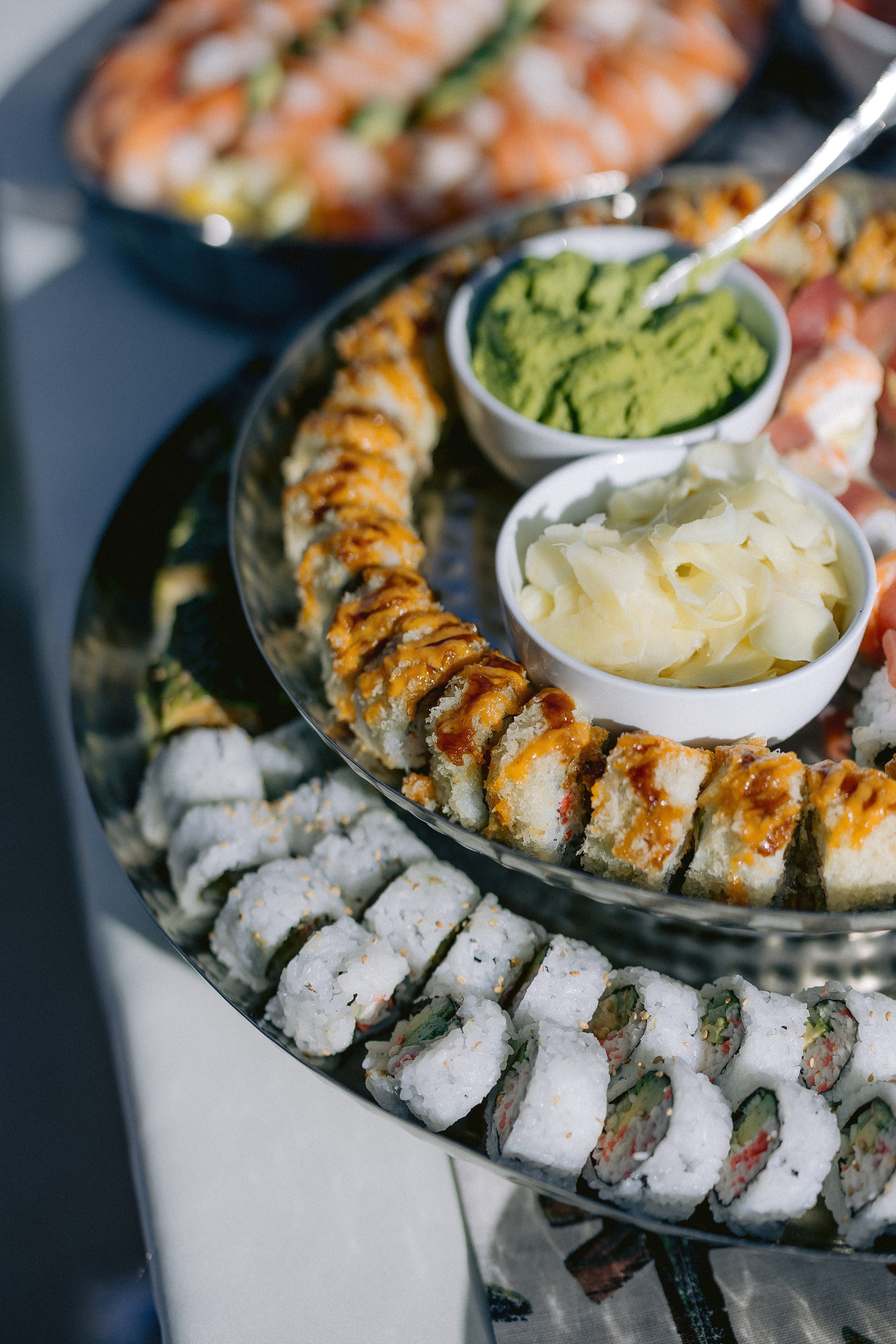 a plate of sushi and other food