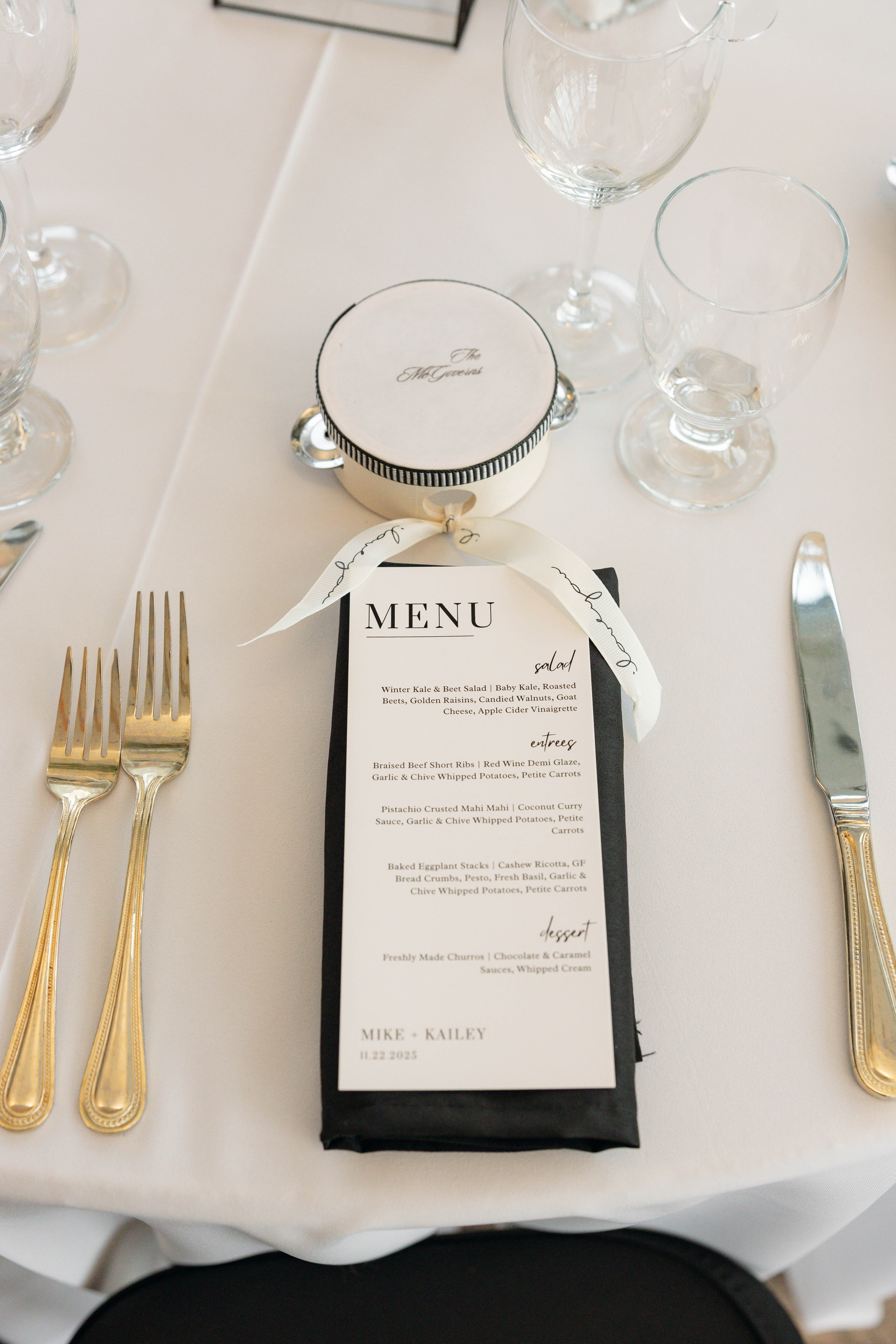 a menu on a table with silverware and glasses