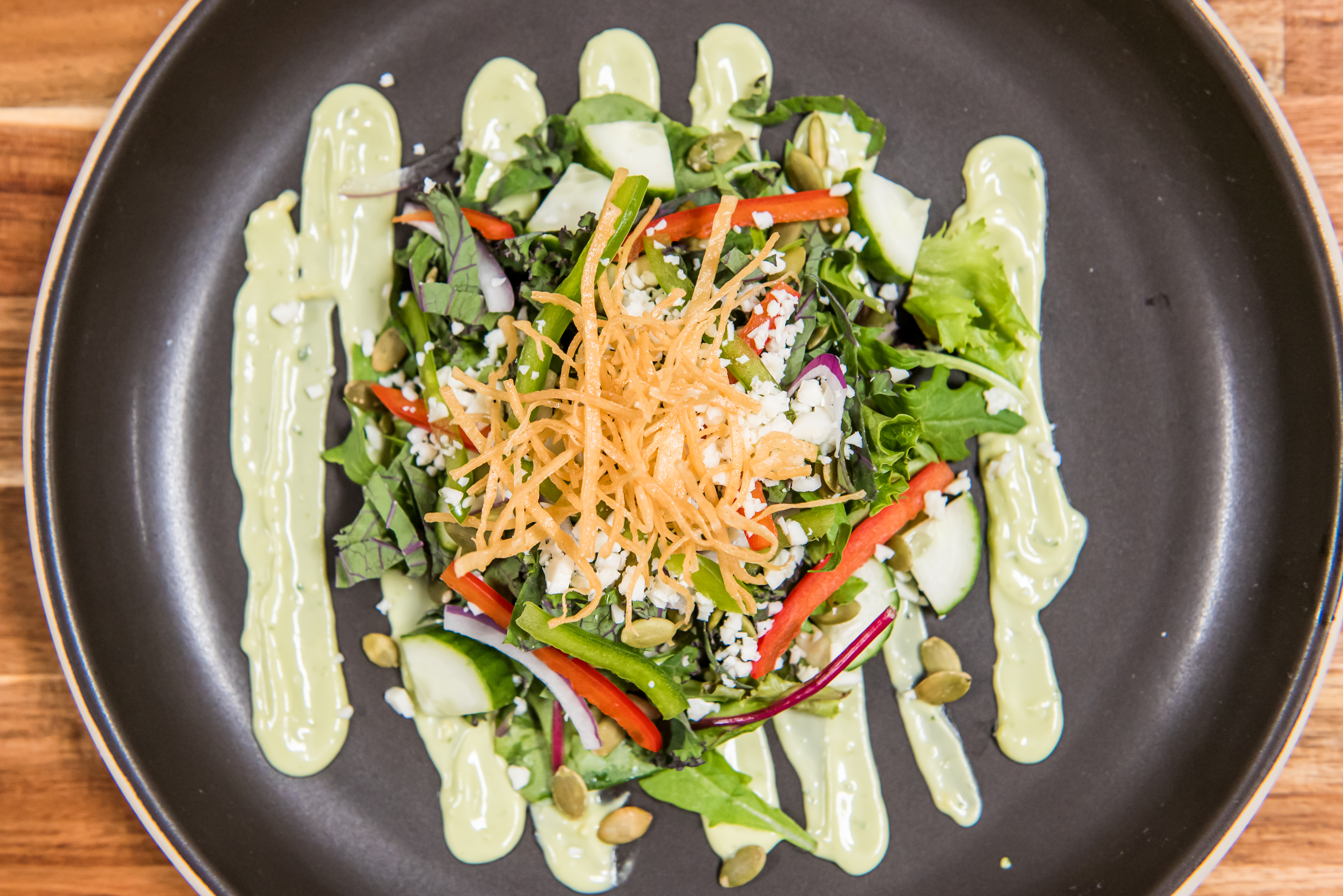 a plate of salad with sauce